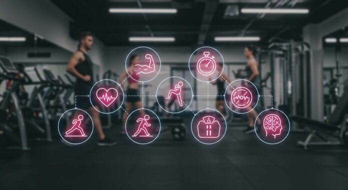 A modern gym with a semi-transparent background of people working out, overlaid with six glowing icons representing the components of fitness for health and wellness. A heart icon symbolises cardiovascular endurance, a flexed arm represents muscular strength, a stopwatch with a muscle highlights muscular endurance, a stretching figure embodies flexibility, a body composition chart signifies body composition awareness, and a calm brain icon represents mental resilience. The icons stand out, reinforcing the interconnected nature of fitness and creating a visually engaging representation of the components of fitness for health and wellness.